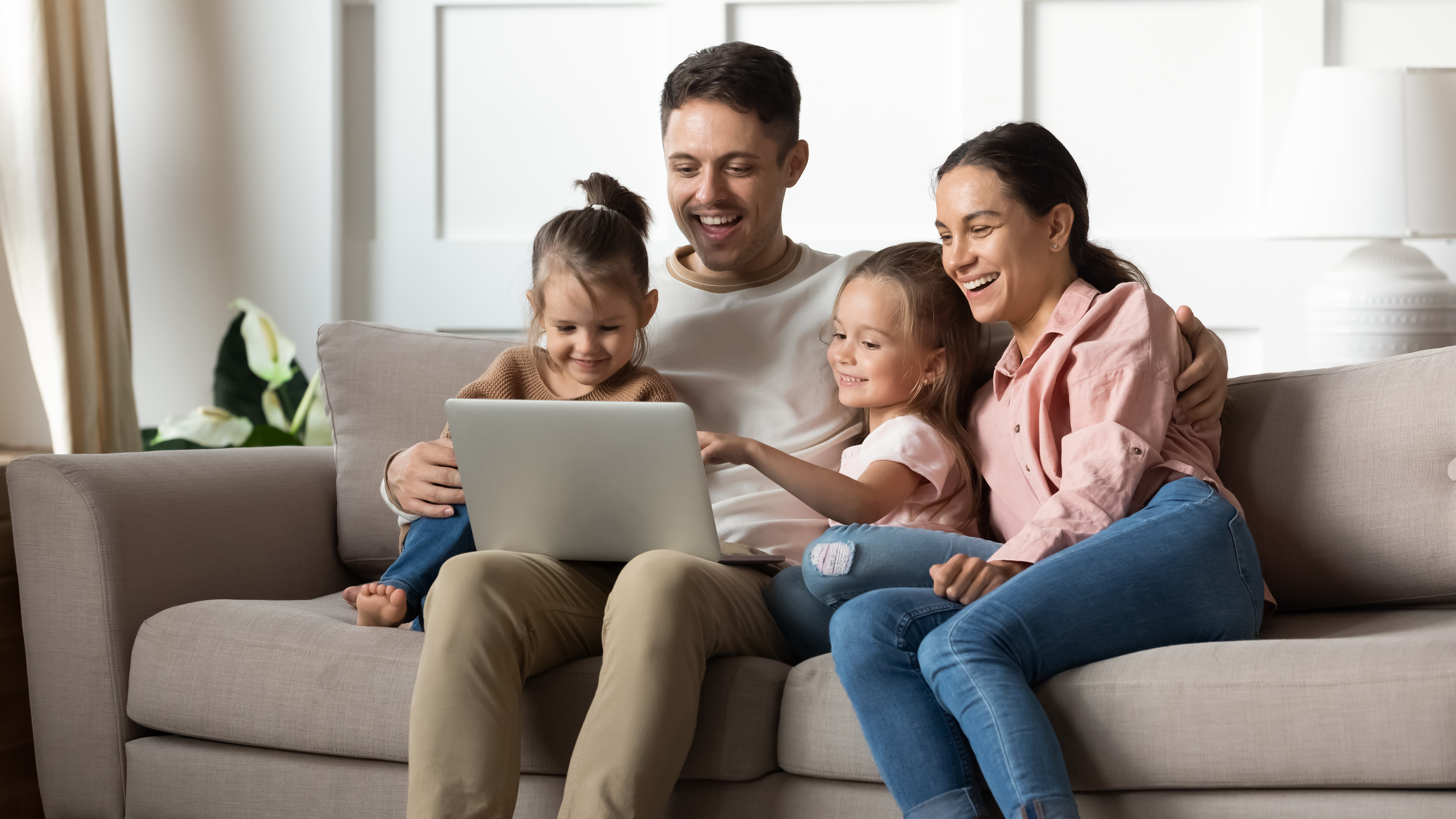 Happy family watching funny movies on computer.